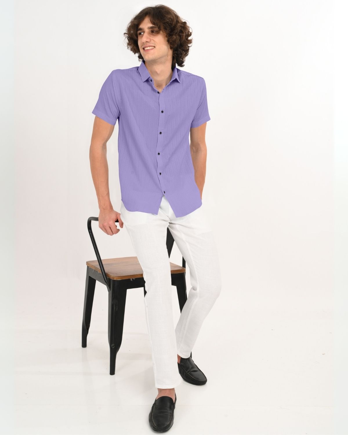 Full body view of man wearing lavender textured short-sleeve shirt