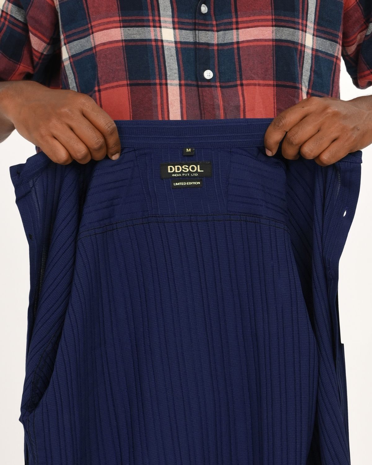 Label close-up of navy blue textured short-sleeve shirt