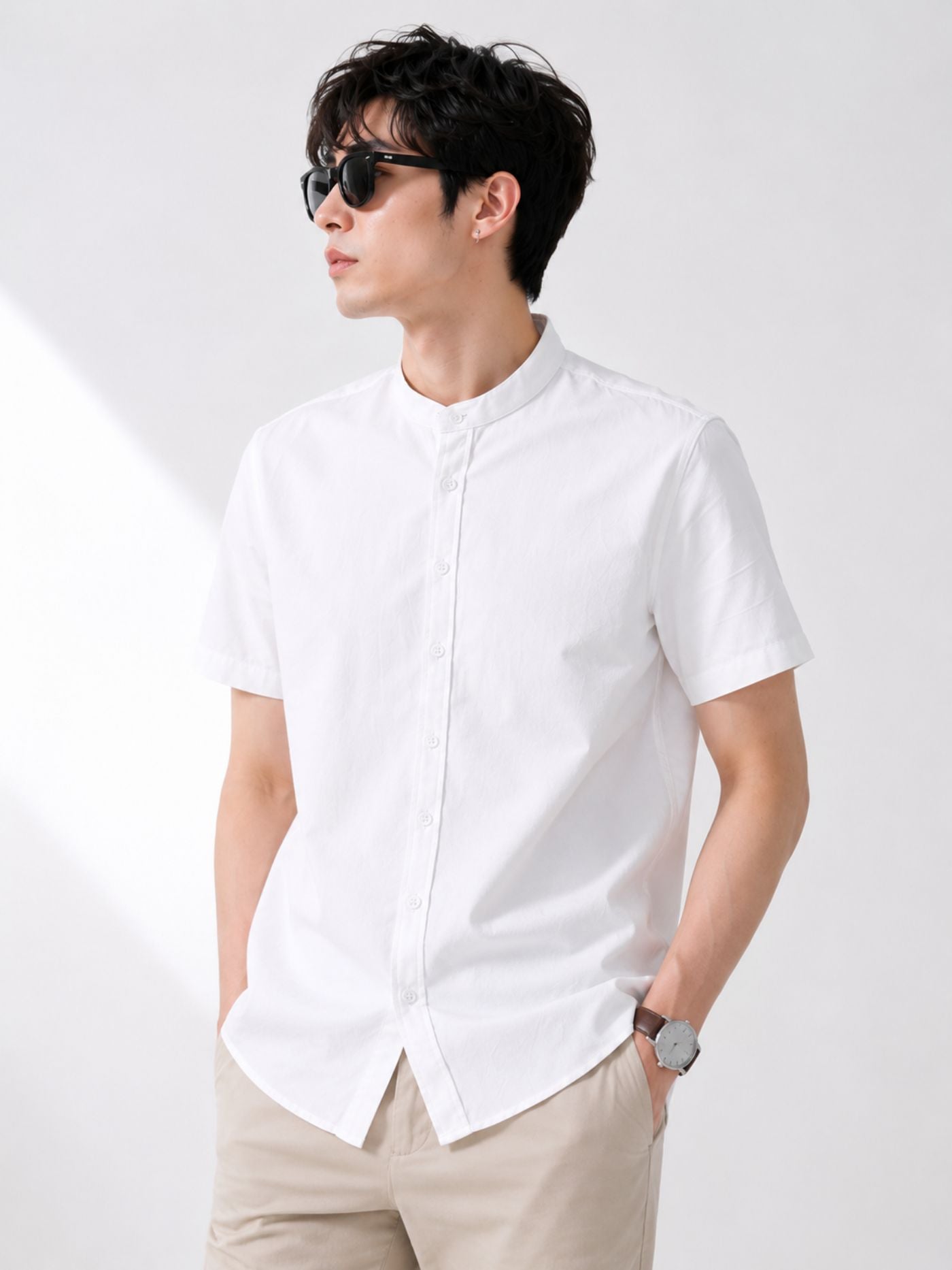 Male model wearing The Blanc Signature Shirt Pure White with beige chinos