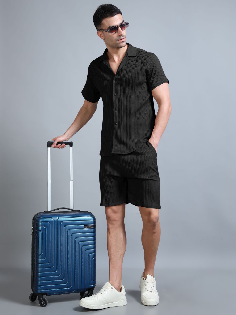 Men’s Lunar Eclipse black co-ord set styled with travel bag
