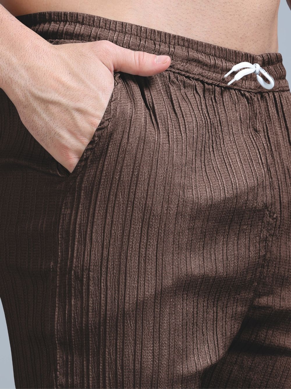 Men’s brown cord pants close-up with drawstring