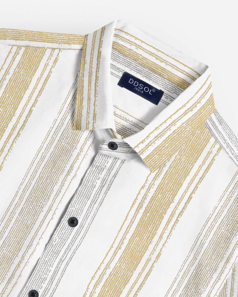 Close-up of men's vertical stripe shirt in mustard and grey showing textured cotton weave, black buttons, and collar detail with DDsol label
