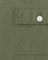 "Close-up of flap pocket with button on olive green men's mandarin collar shirt"


