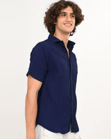 Angled front view of navy blue textured short-sleeve shirt for men