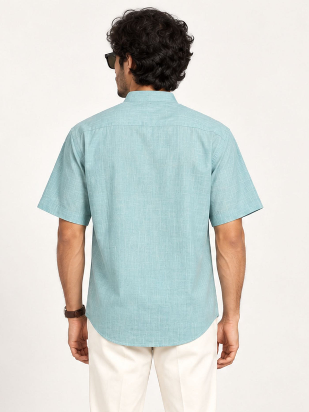 Back view of Aavir seafoam blue cotton kurta shirt showing plain back and curved hem