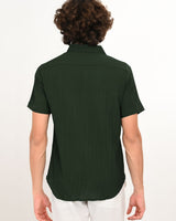 Back view of dark green textured short-sleeve shirt for men.