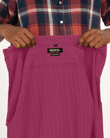 Close-up of DDSOL label inside magenta shirt.