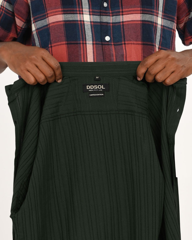 Close-up of clothing tag inside dark green textured short-sleeve shirt showing DDSOL branding.