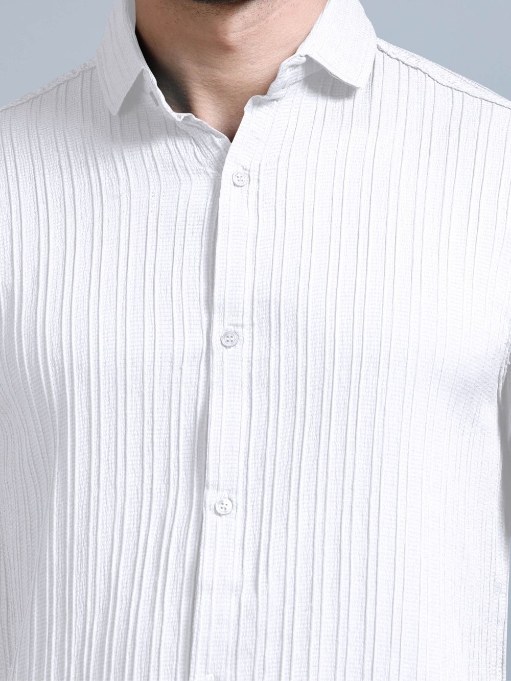 Close-up of ivory white cord shirt buttons