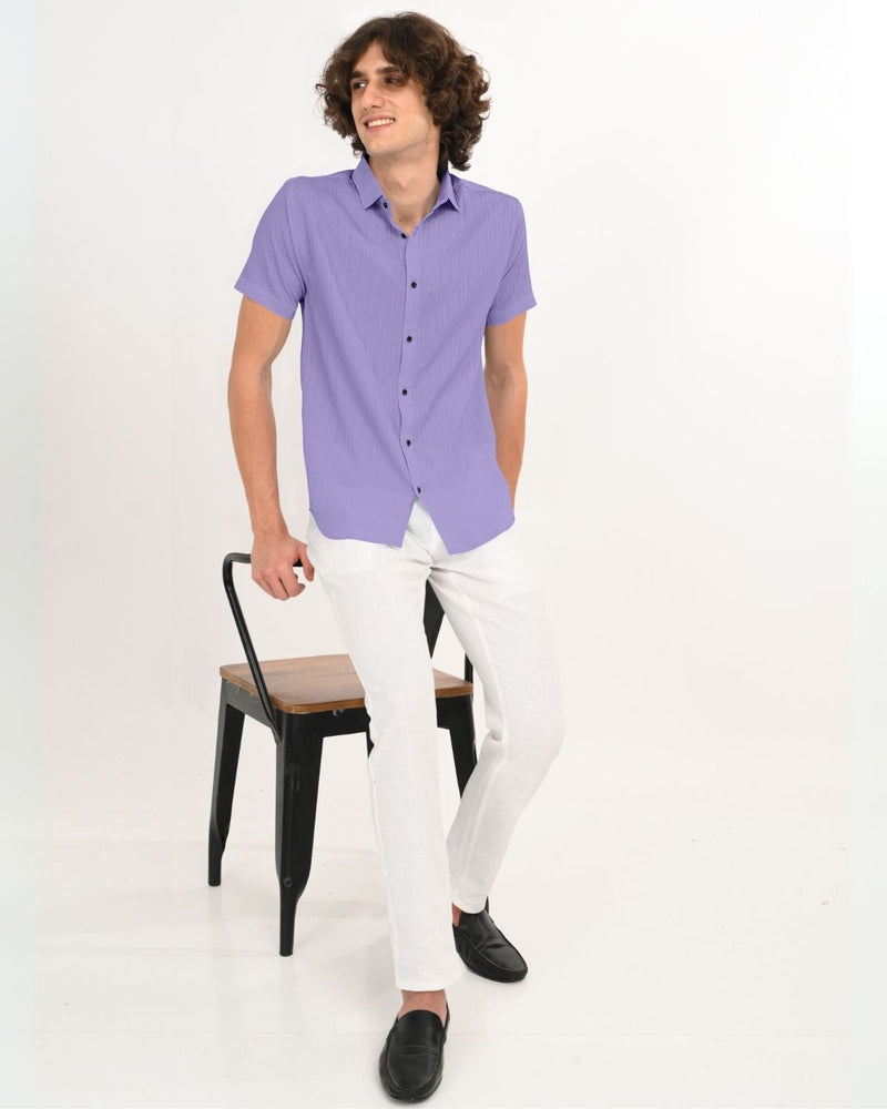 Full body view of man wearing lavender textured short-sleeve shirt