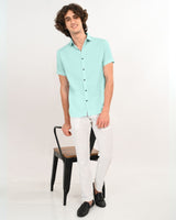 Full body view styling mint green textured short-sleeve shirt with white pants