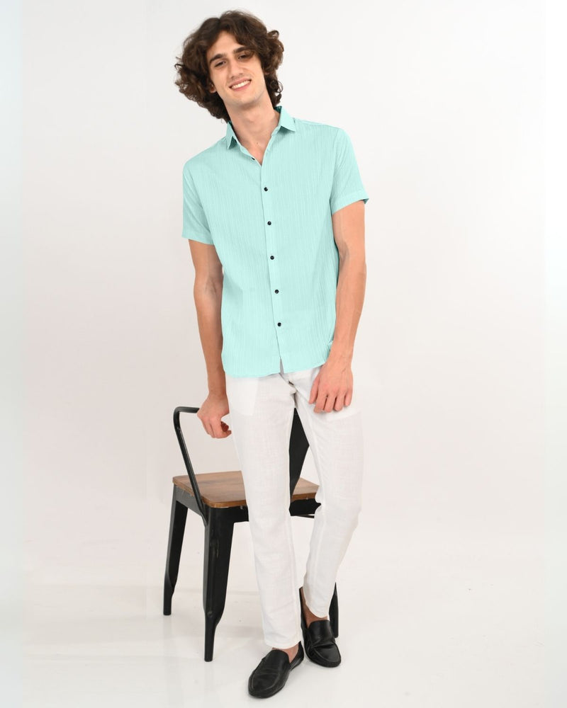 Full body view styling mint green textured short-sleeve shirt with white pants
