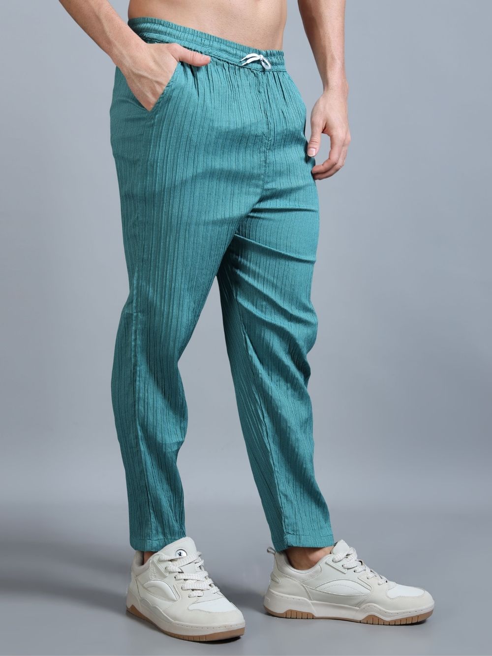 Lifestyle shot of men’s teal green cord set casual wear