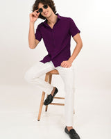 Man sitting wearing Royal Plum short-sleeve textured shirt