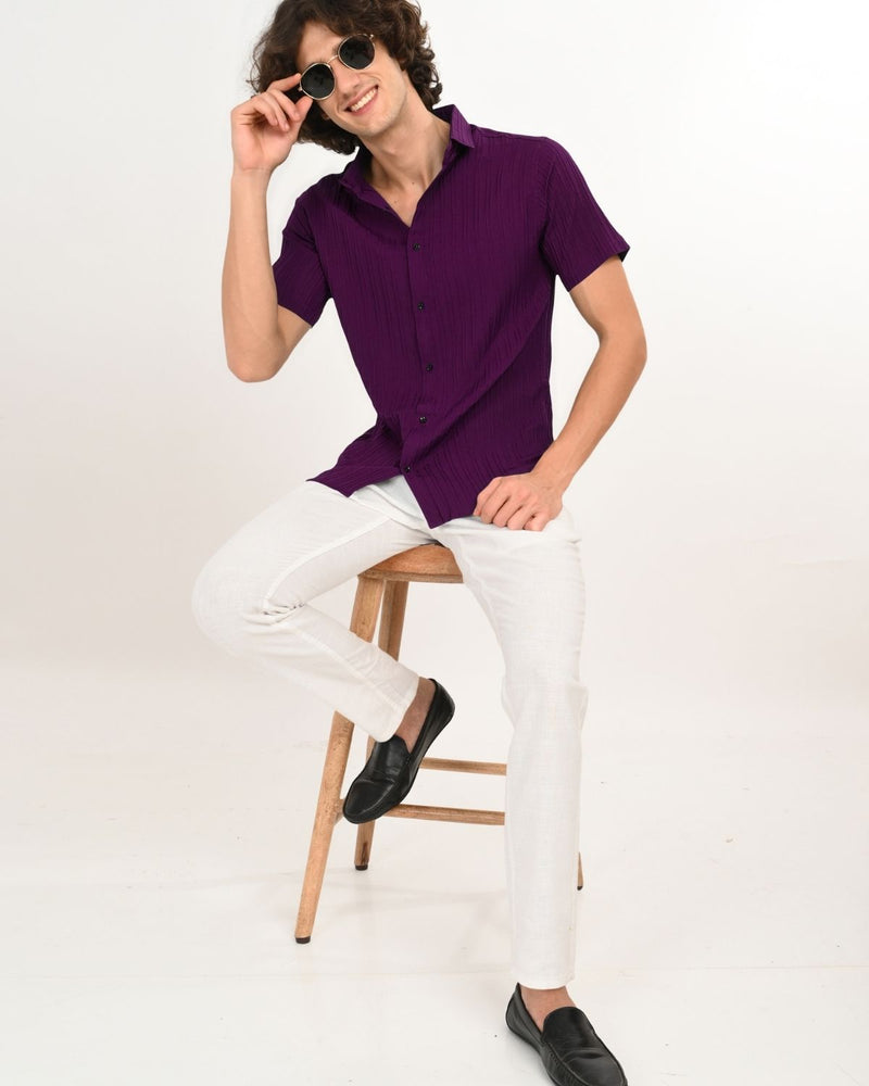 Man sitting wearing Royal Plum short-sleeve textured shirt