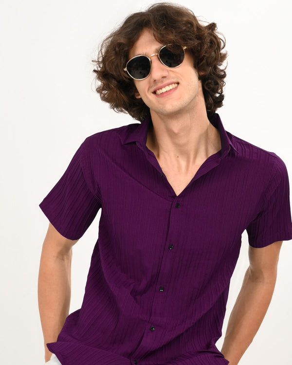 Man smiling in Royal Plum textured short-sleeve shirt