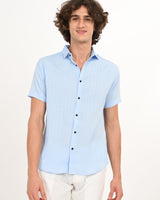 Man smiling in Skyline Blue short-sleeve textured shirt.