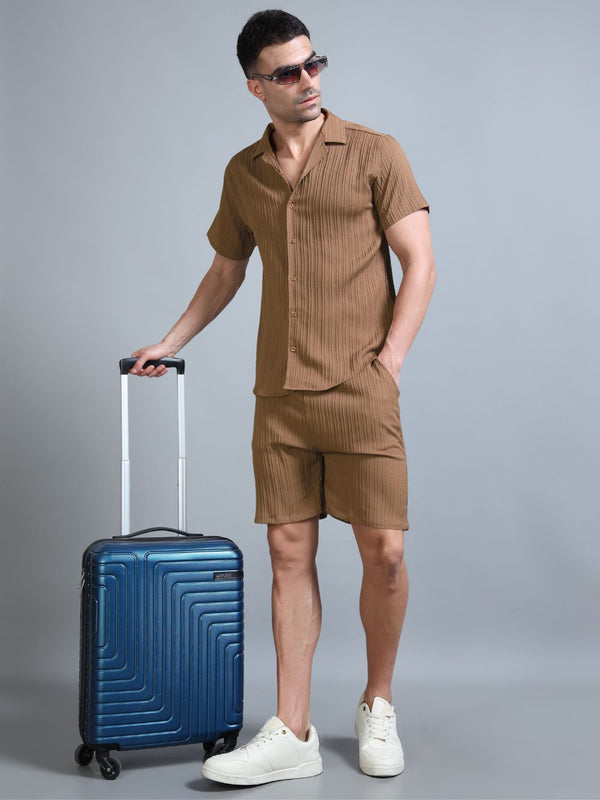 Men’s brown Terracotta Glow co-ord set in relaxed seated pos
