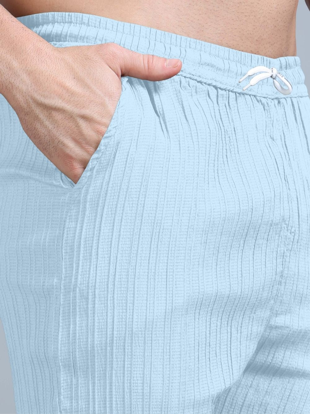 Men’s sky blue cord set seated pose