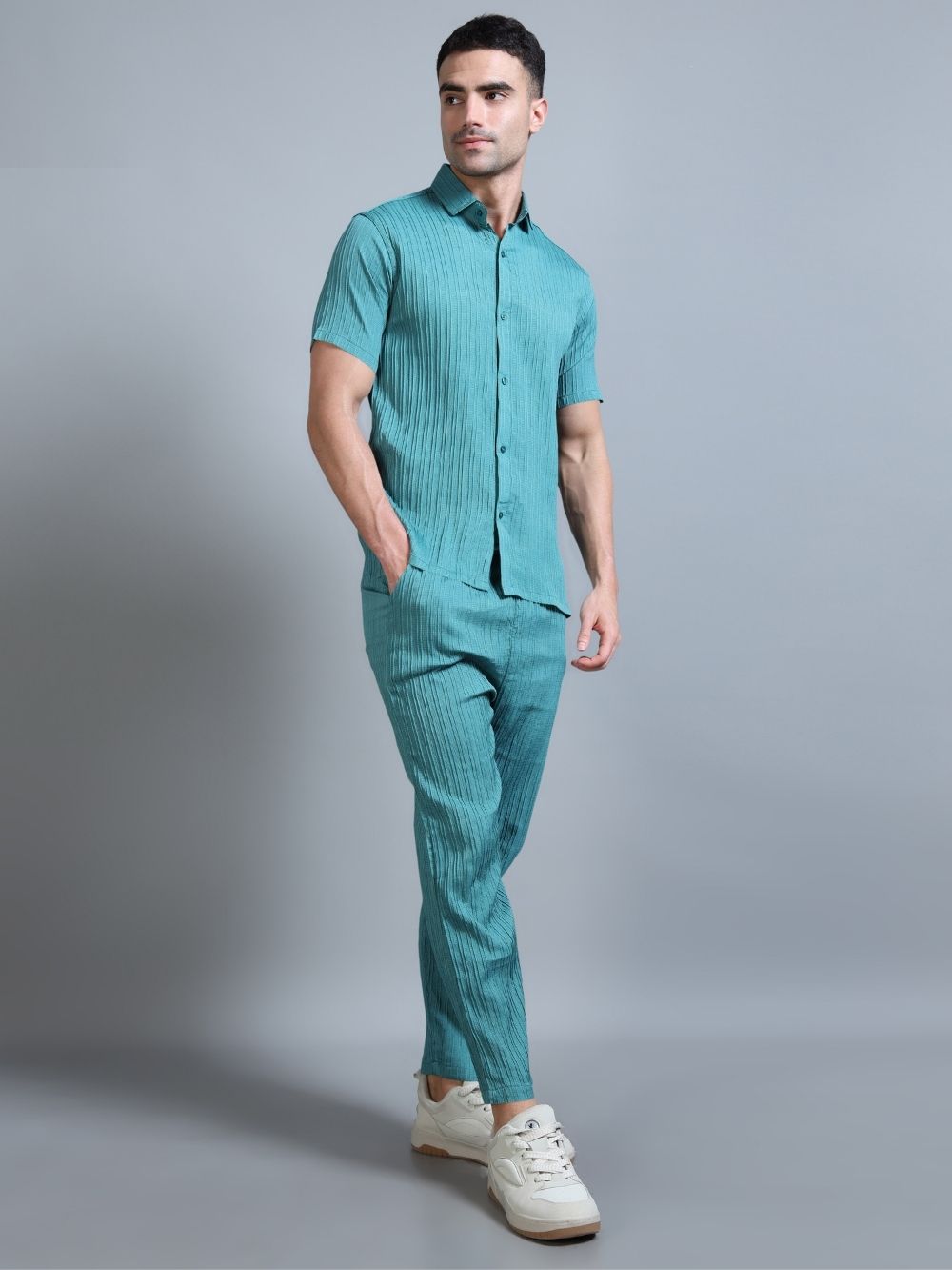 Men’s teal green cord set styled with sneakers