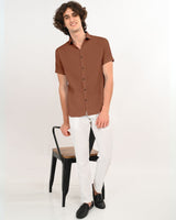 Rust brown textured shirt styled with white pants