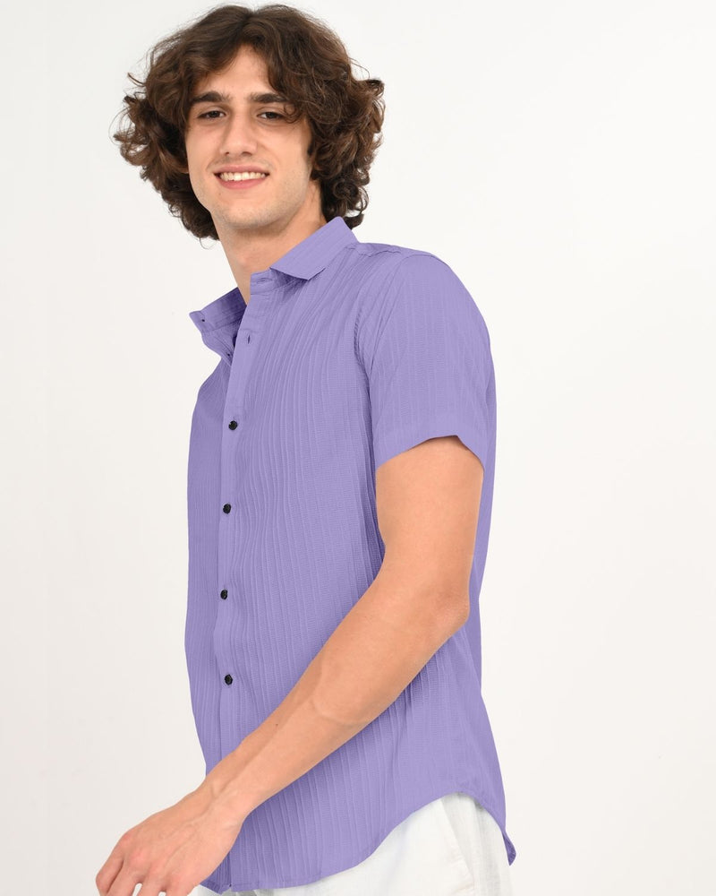 Side angle of man in lavender textured short-sleeve shirt