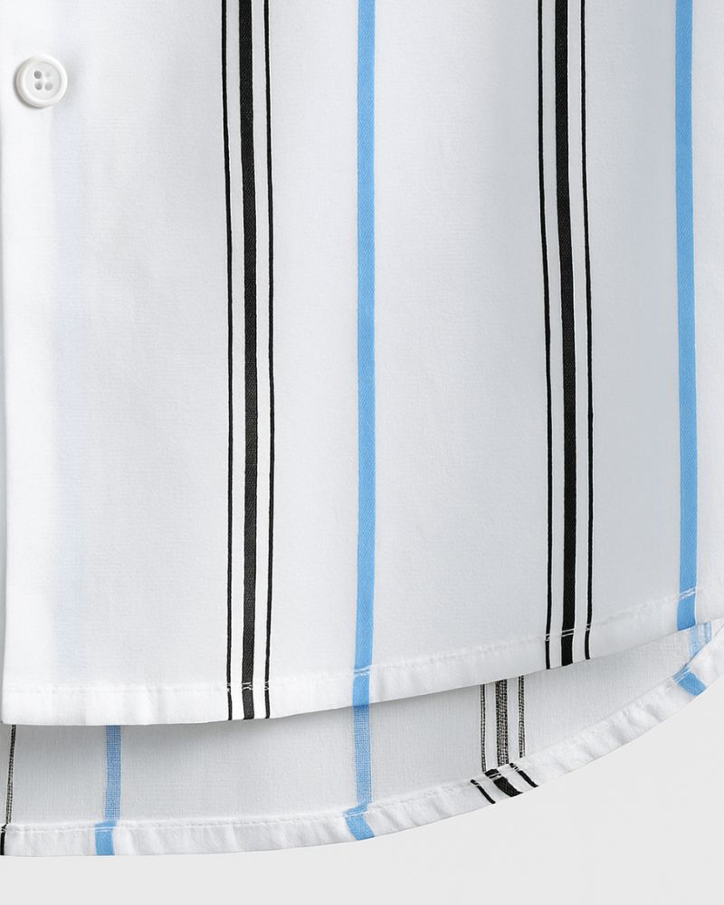 Close-up view of curved hem of men's white shirt with blue and black stripes and visible button placket

