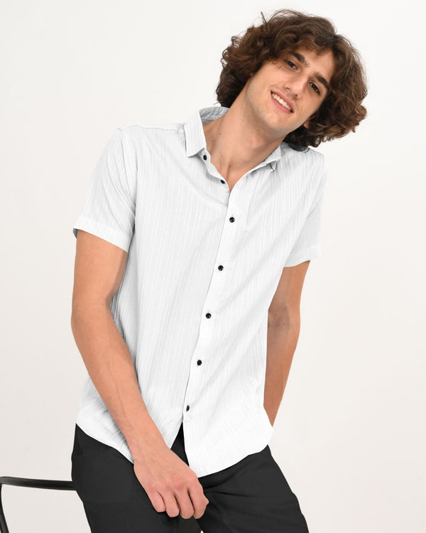 White textured shirt styled casually sitting pose