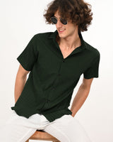 dark green textured casual shirt and white pants